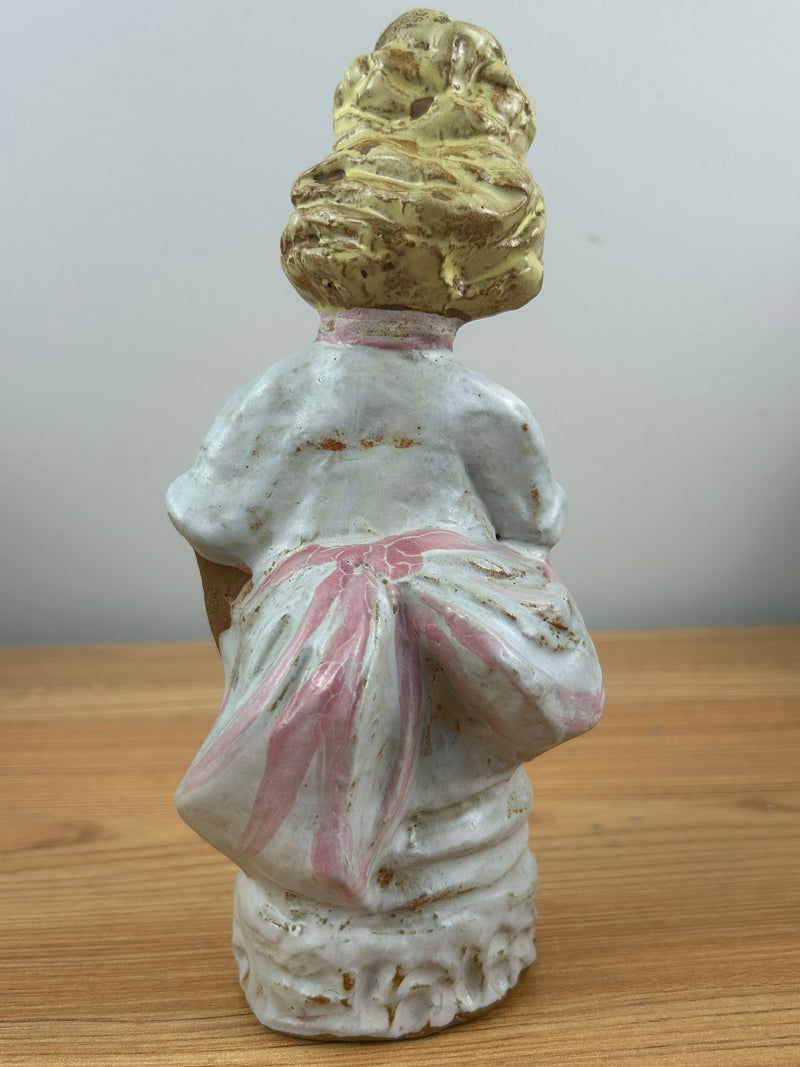 Metlox pottery Poppets BY Poppytrail. Girl with yellow hair, bustle dress carrying a basket for flower